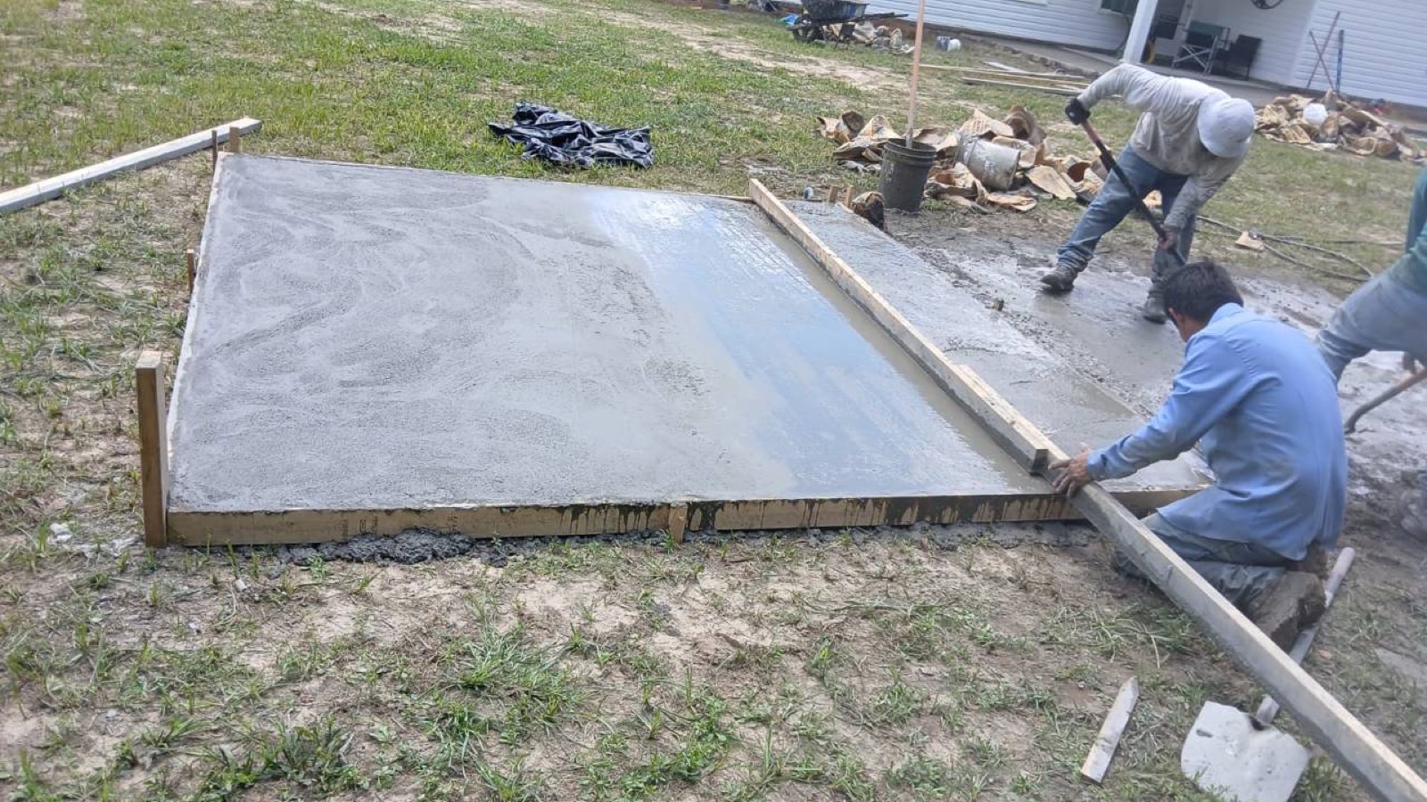 Hand-finishing a freshly poured concrete patio in Savannah GA