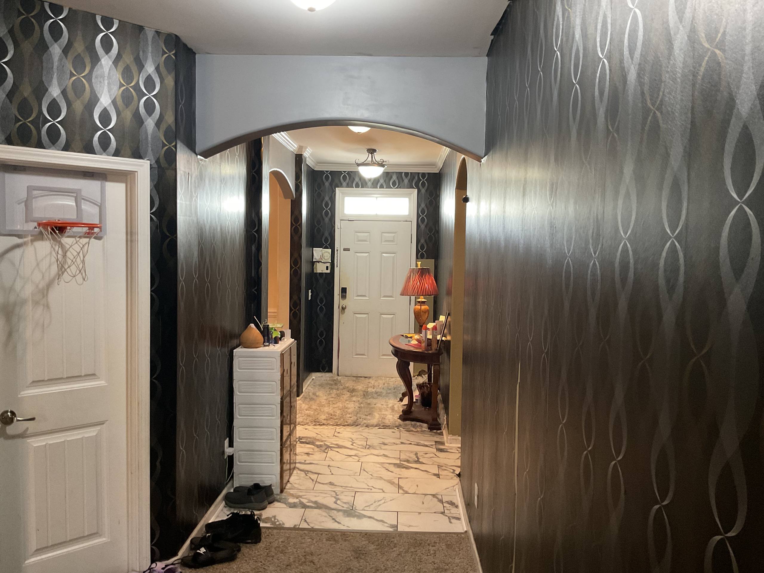 Before - dark metallic wallpaper through archway in Richmond Hill GA hallway