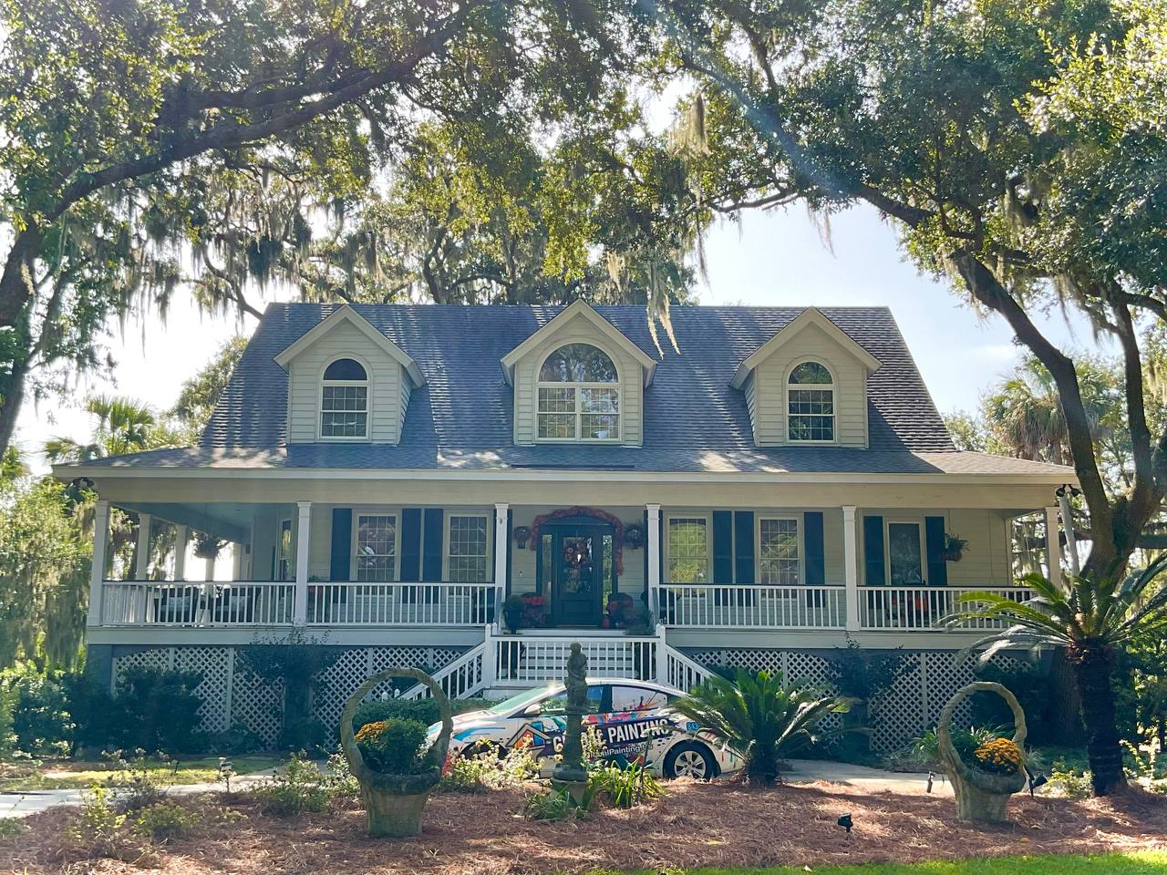 Lowcountry home exterior painting by Global Painting - company truck on-site in Savannah GA Lowcountry