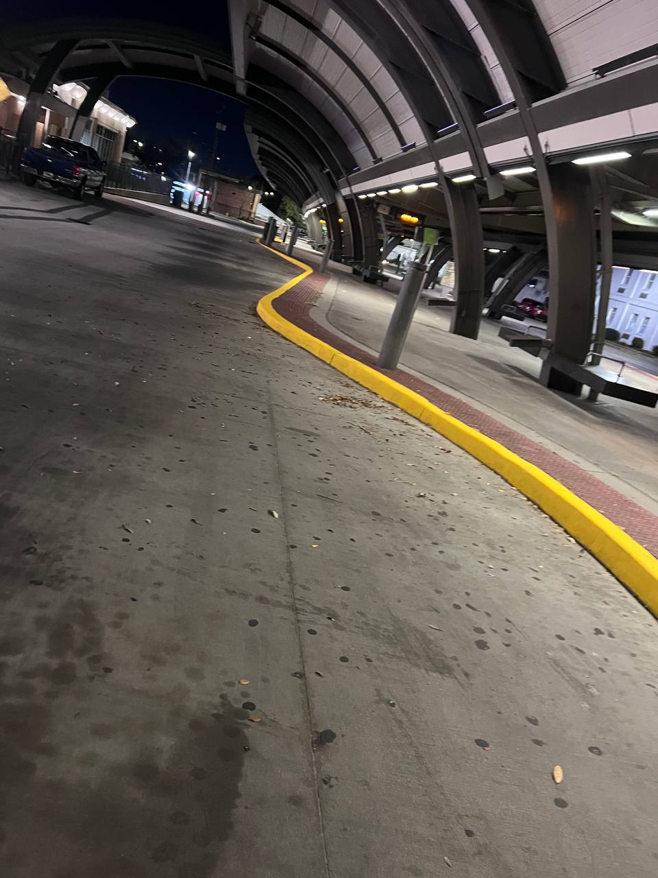 Fresh yellow curb paint at CAT Bus Station Savannah at night - Global Painting commercial project