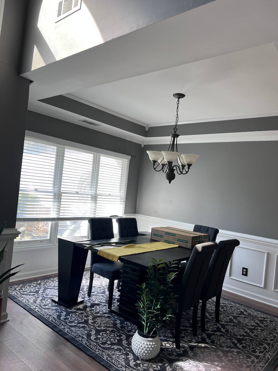 Professional interior painting - dining room with dark gray walls and white wainscoting in Hilton Head