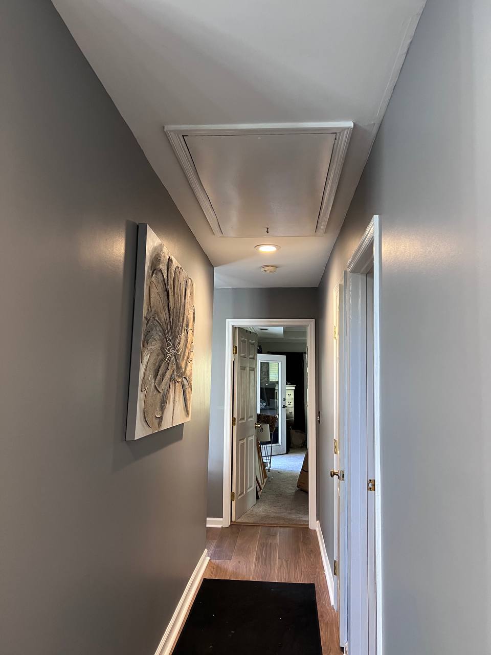 Freshly painted hallway with Agreeable Gray walls and white trim