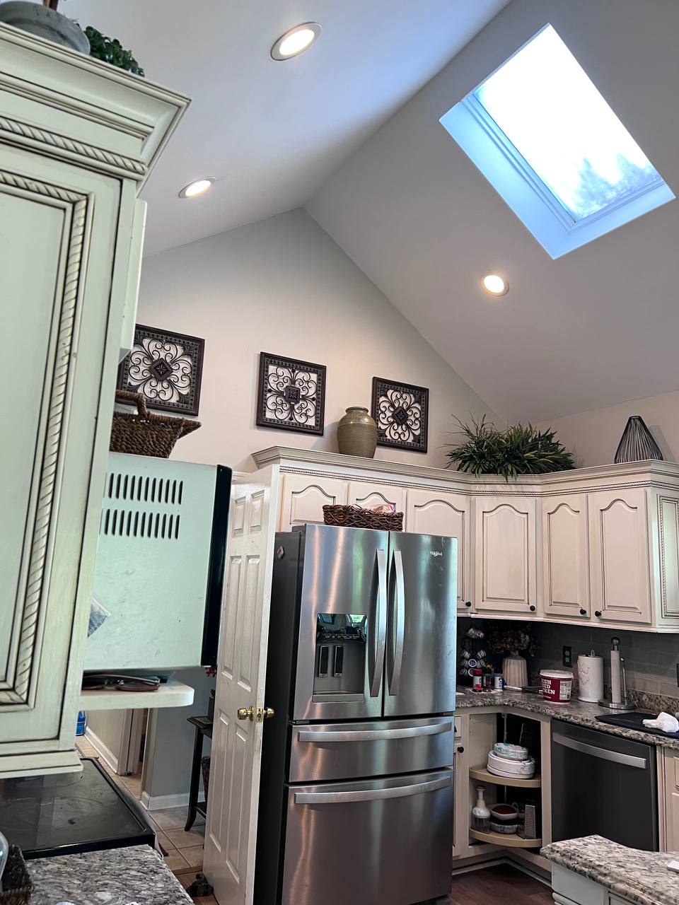 Kitchen painted in Agreeable Gray with vaulted ceiling and skylight by Global Painting in Hilton Head