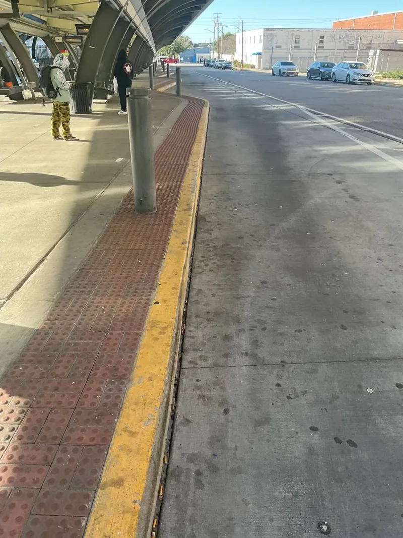 Worn, faded curb at the bus station