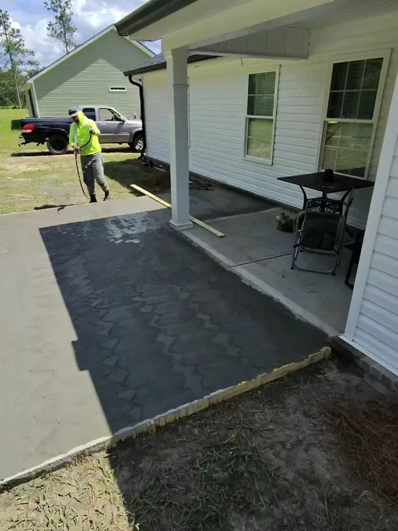 Finished concrete patio extension beside the porch