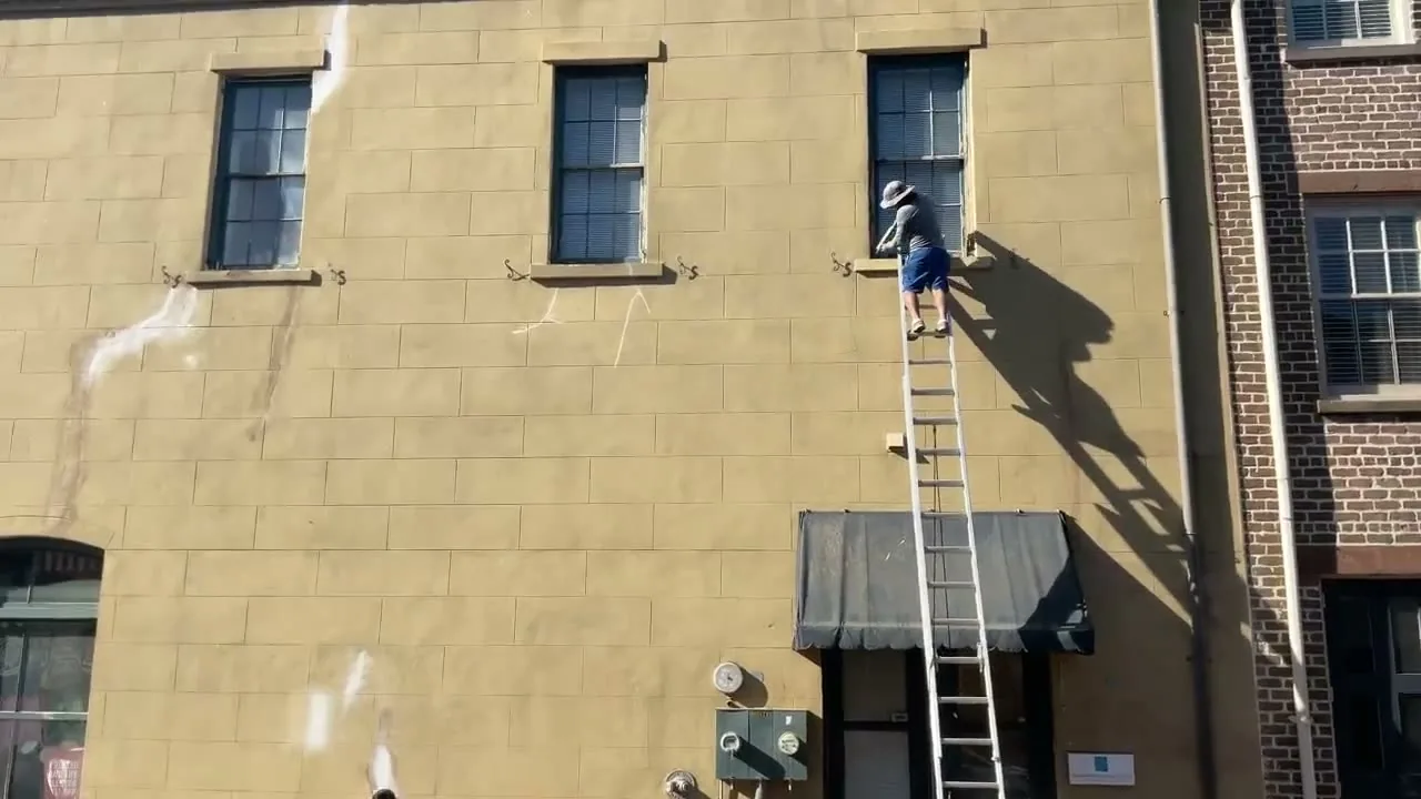 Global Finishes crew repainting a downtown Savannah storefront