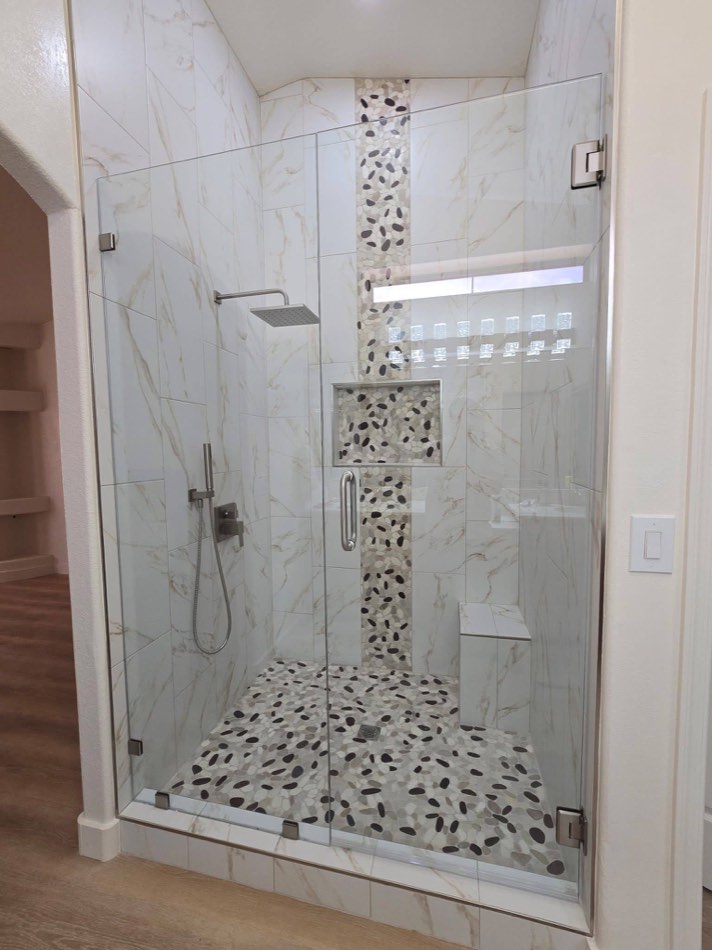 Marble shower with pebble accent stripe down the middle