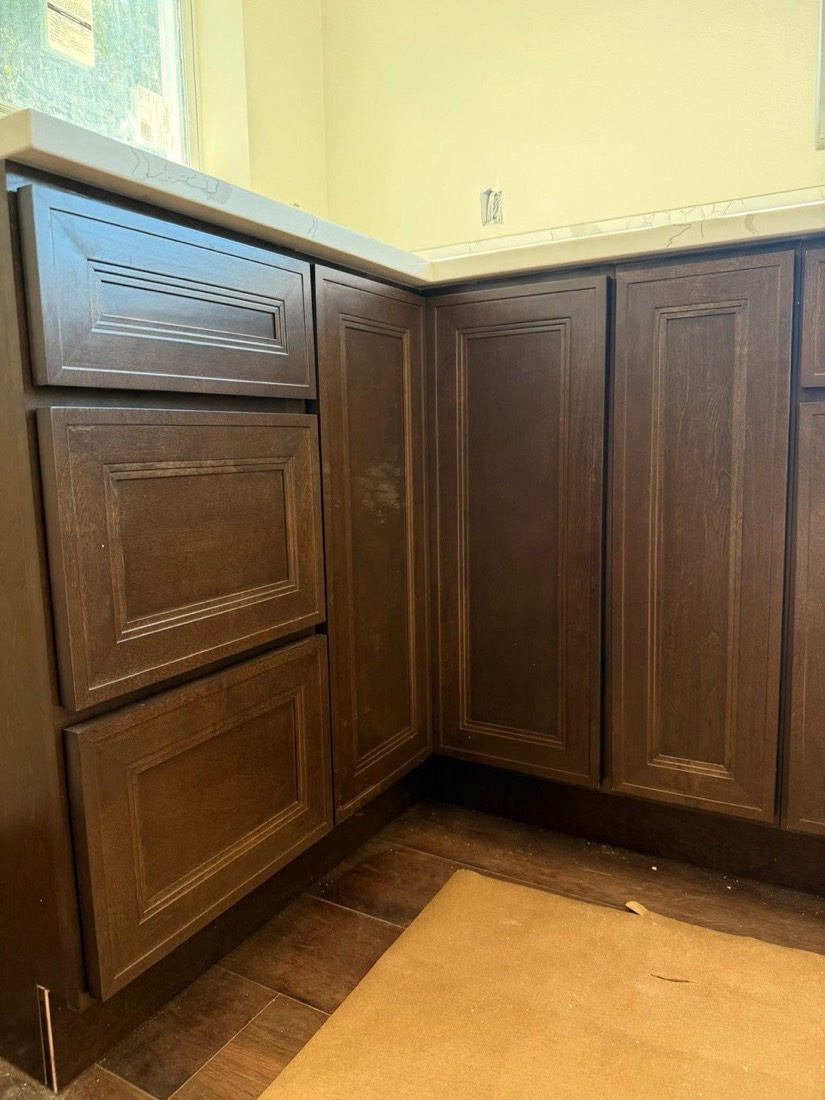 Dark base cabinets installed in real construction context