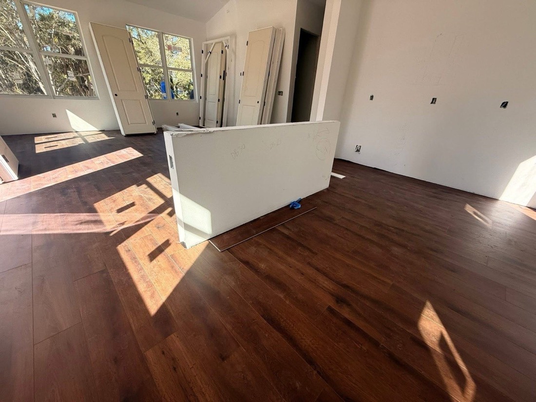 Cabinet doors stacked ready for install on hardwood floor