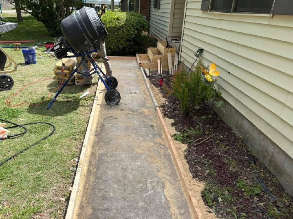 Concrete mixer pouring walkway with formwork in place