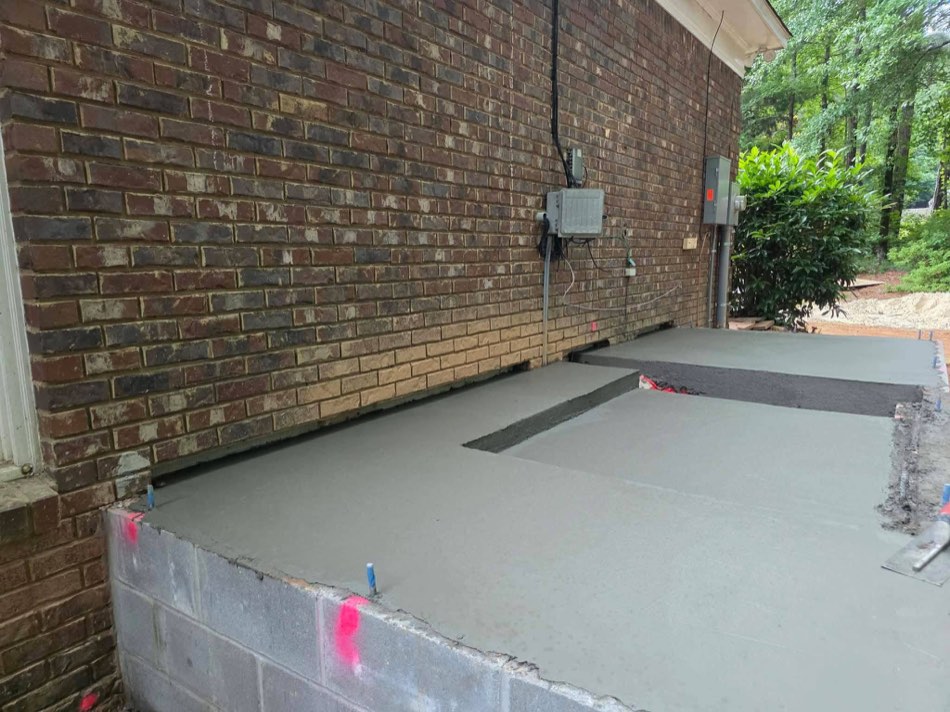 Foundation footing with rebar against brick wall