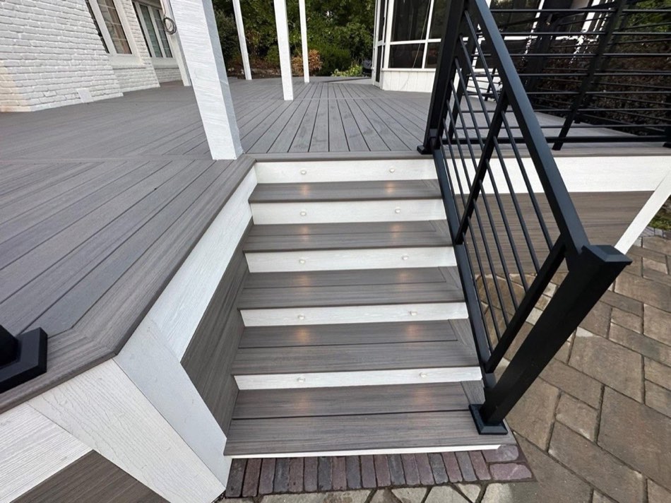 Composite stairs with riser lights and black metal railing