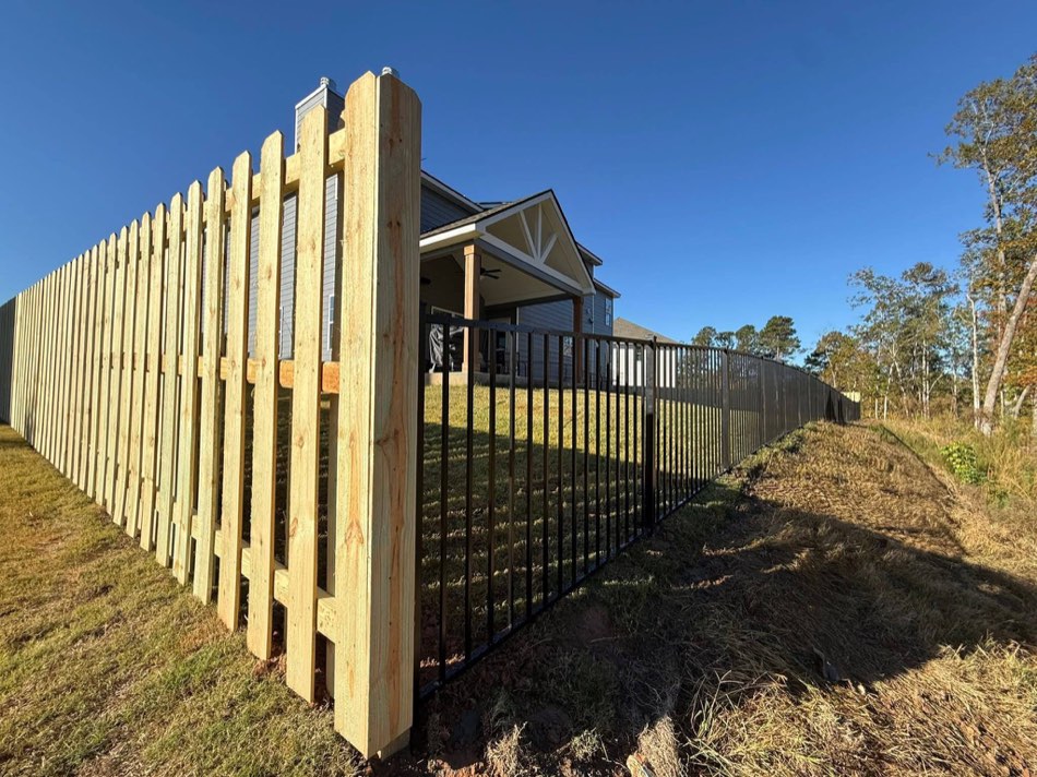 Black-stained shadowbox along a wooded property line