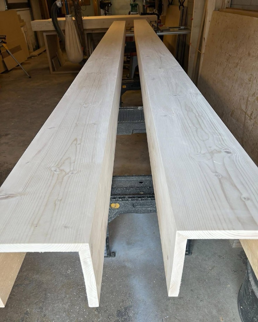 Long planed beam lumber in production on a workbench